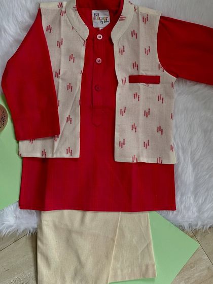 This elegant red and ivory ensemble is perfect for celebrations. The solid red kurta is paired with a subtly printed Nehru jacket, offering a look that is both traditional and modern.