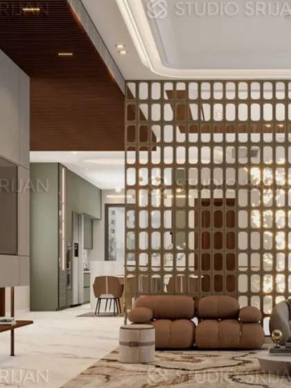 An open-plan view of the Model Town lobby, showing how the jaali screen separates the seating area from the kitchen, creating distinct zones within a large space.