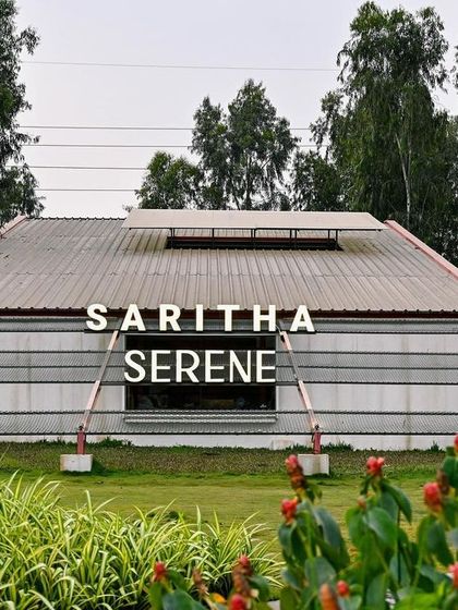 A frontal view of the Saritha Serene office, where the building's name is integrated into the facade. The design is simple yet bold, creating a strong brand presence in the landscape.