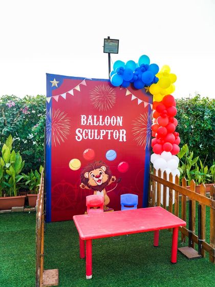 A dedicated stall for a balloon sculptor, where kids can get custom balloon animals and shapes.