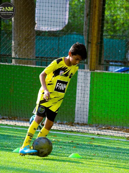 A player dribbles through cones with precision, a fundamental drill for improving close control.
