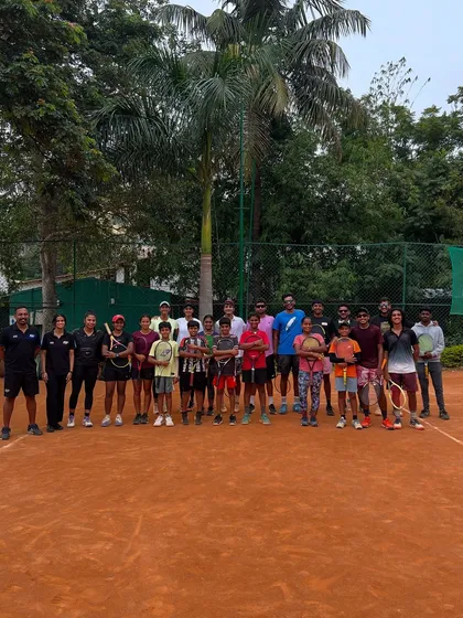A group photo of our athletes and coaches after a collaborative on-court fitness session with a partner tennis academy. This highlights our engagement with the broader sports community.