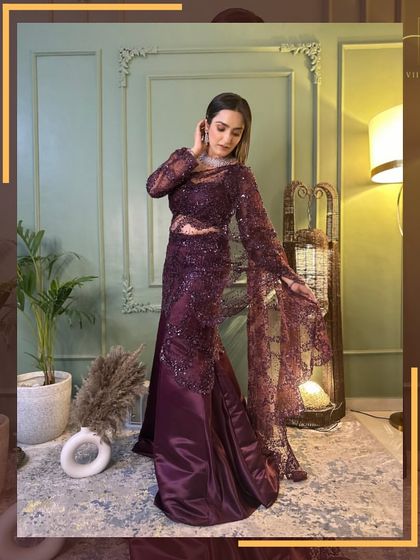 A full-length shot of the wine-colored drape saree gown, a glamorous choice for a reception or cocktail event.