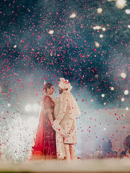 A shower of rose petals and a sky full of fireworks create a truly magical atmosphere for the couple's portrait. This is the kind of grand, romantic moment we are known for creating.
