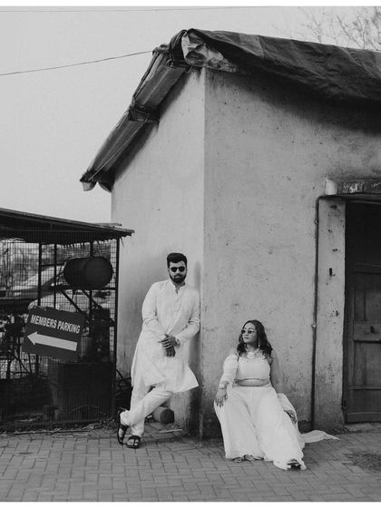 A cool, editorial-style portrait of Nikita and Harsh during their Haldi. The black and white processing and their relaxed poses give this shot a modern, stylish feel.