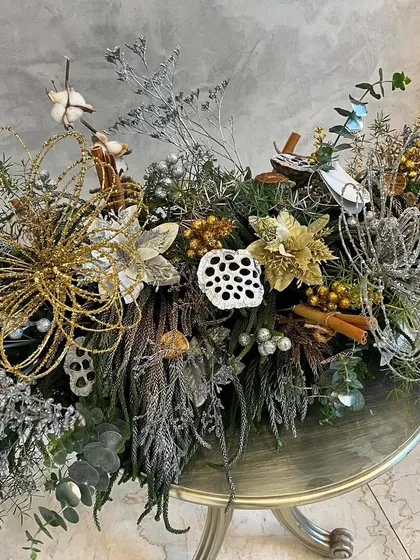This "Glistening Silver Lace" arrangement was designed for a Christmas party. I used sparkly silver and gold elements, dried foliage, and festive greens to create an elegant and celebratory floral runner.