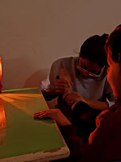 We use sensory tools to create a focused learning environment. In this occupational therapy session, a lava lamp provides gentle visual stimulation, helping the child remain calm and engaged with the therapist.
