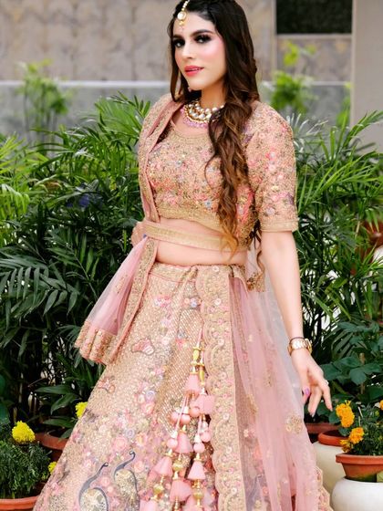 A three-quarter view of the client's lehenga, showing off the cute tassels and the beautiful drape of the dupatta. Smart fashion looks this good.