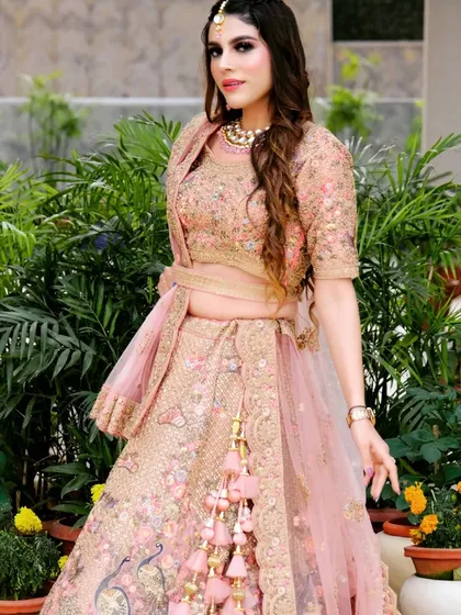 This beautiful pink lehenga with its unique peplum-style blouse is a true fashion statement.