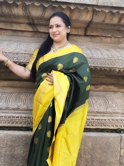 This antique Kanjivaram silk saree in dark green and yellow is a masterpiece of heritage, worn beautifully by our client.