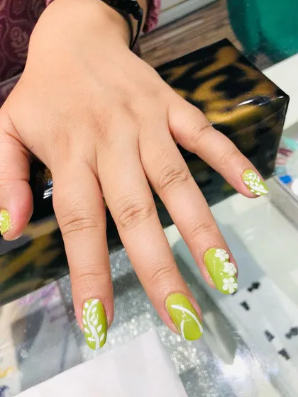 A full view of the hand with the pretty lime green and white floral design.