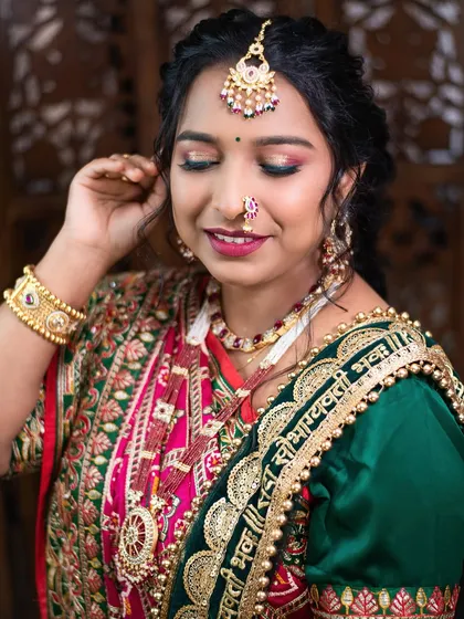 A close-up of the colorful eye makeup for the Gujarati sider look, blending pink and green shades.