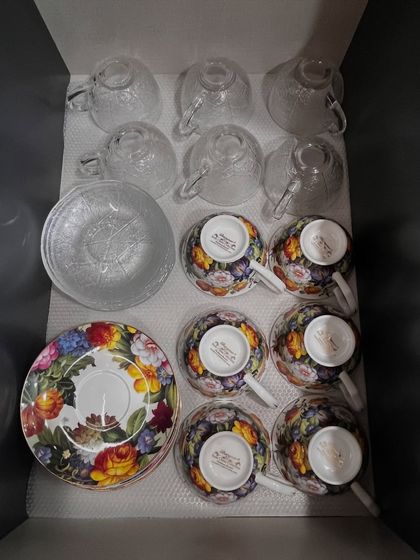 A close-up of a tea set being packed or unpacked. We handle all items with care, ensuring your precious crockery is safe during the organization process.