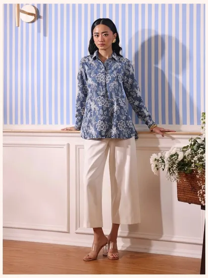 This blue floral print shirt can be paired with white pants for a stylish co-ord look. It’s a versatile piece that’s easy to dress up or down.