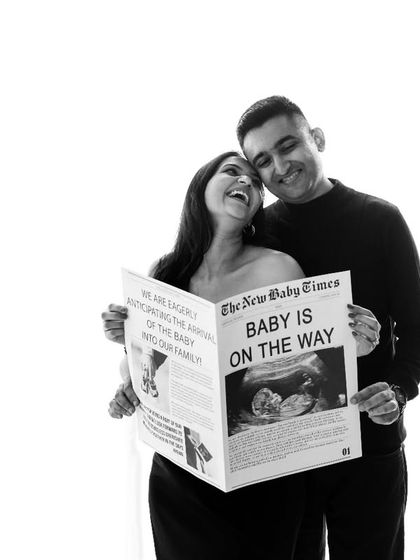 Extra, extra, read all about it! I love this creative newspaper prop that announces "Baby is on the Way." It's a unique and memorable idea for a pregnancy announcement, captured here in a timeless black and white photo.