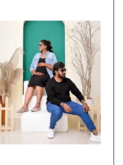 A cool and casual pose from a modern maternity shoot. The sunglasses and relaxed posture give this couple's portrait a confident and stylish vibe.