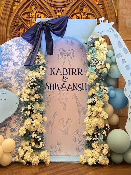 For the arrival of twin boys, we created an elegant animal-themed decor using a sophisticated blue and white toile pattern as a backdrop, paired with custom animal cutouts.