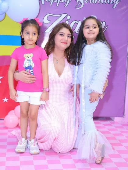 A mother and her two daughters at a princess-themed party. The birthday girl is dressed as a mermaid, showing how we can mix and match magical themes.