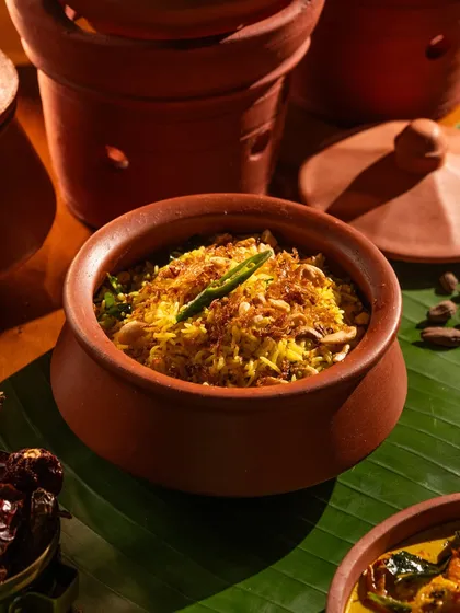 A flavorful biryani or pulao in a clay pot. The presentation enhances the authenticity of the dish.