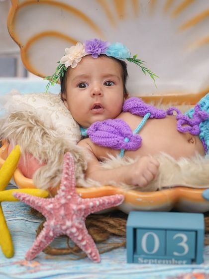 A wider shot of the seashell setup, showing the calendar block for a milestone photo.