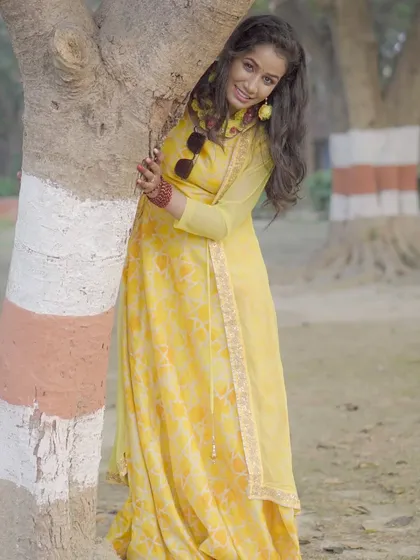 Another playful pose from the same outdoor shoot, using a painted tree as part of the composition.