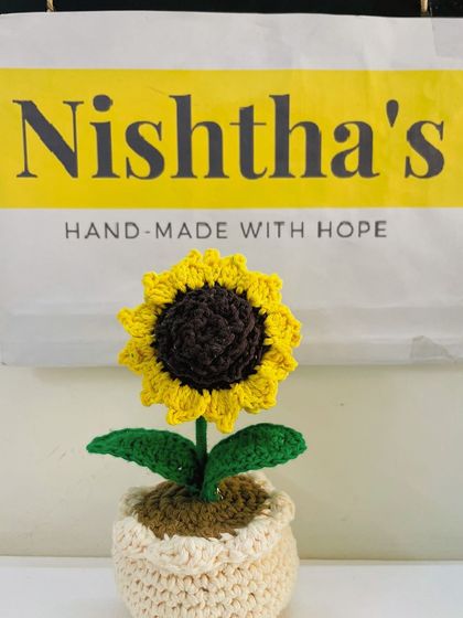 My little sunflower pot sitting proudly in front of our brand packaging. Each piece is handmade with hope and sent out to bring a smile to your face.