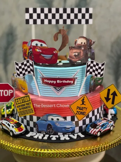 One of my most popular designs for kids' birthdays. This two-tier Lightning McQueen cake brings the race track to the party, complete with all the favorite characters. This one was made with my special Royal Rasmalai flavour.