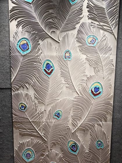A stunning peacock feather mural carved in stone with inlaid colored mosaic. This is a perfect example of our mixed-media approach to creating unique feature walls for mandir or prayer areas.