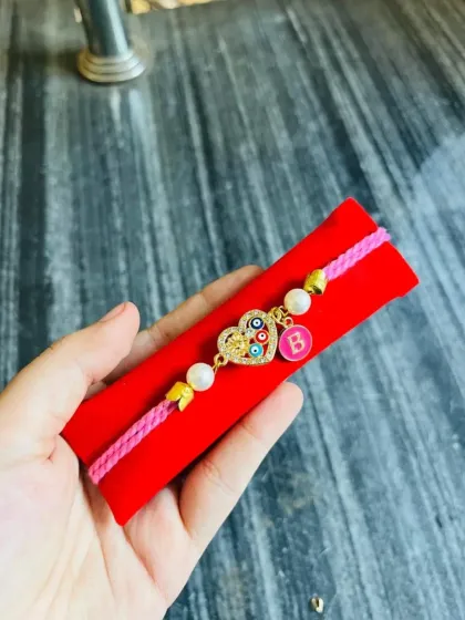 Customize this evil eye heart charm bracelet with an initial. It's a perfect, personal gift for Raksha Bandhan or Friendship Day.