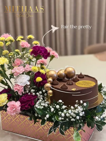 I love creating gifts that are a feast for the eyes and the palate. Here, I have paired a decadent chocolate cake with a fresh, vibrant floral arrangement, creating a complete and thoughtful celebratory package.
