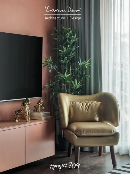 To bring a touch of luxury to the living room, we added this statement chair in a golden fabric. It sits next to the TV unit, which is colored the same as the wall to help it blend in seamlessly.