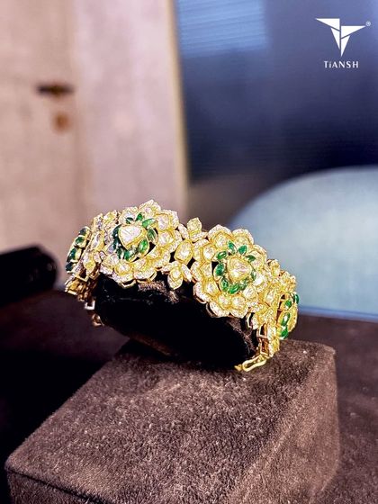 You know that one piece you reach for every single wedding? This is that bracelet. Handset with delicate polkis and emerald blooms, it has just enough sparkle to make your wrists do all the talking.