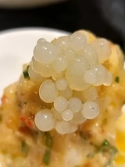 Bird's Eye Chilli Kaffir Lime Prawns topped with lemon caviar. This dish is a perfect example of our Lux Asian menu, combining bold flavours with elegant presentation.