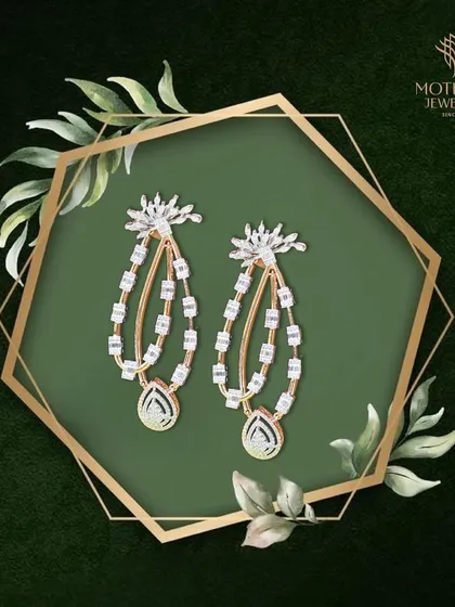 A pair of delicate and modern chandelier earrings, featuring cascades of baguette and pear-shaped diamonds. Their design creates a beautiful sense of movement and light.