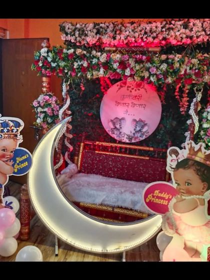 A close-up of the decorated swing and lighted moon prop, a popular combination for modern baby showers that I provide.