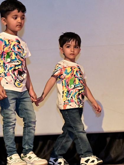 Yuvaan holding hands with his fellow performer, a beautiful display of camaraderie among our little dancers.
