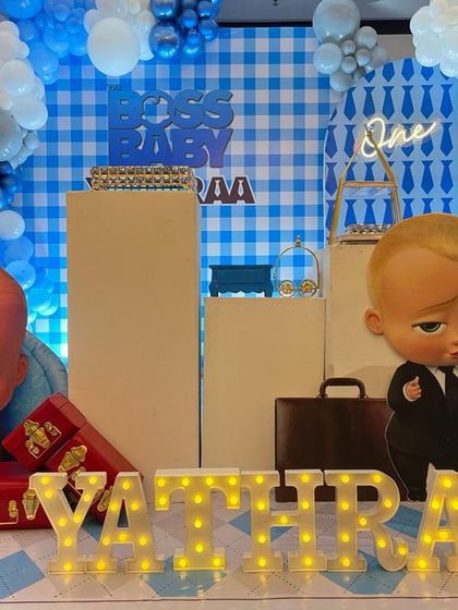 This Boss Baby setup uses a blue gingham backdrop and life size character cutouts to create a playful and corporate-cute atmosphere.
