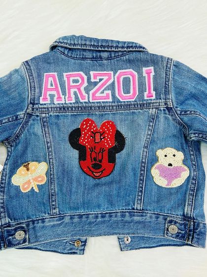 A super cute Minnie Mouse themed denim jacket for a little fashionista. The pink varsity letters and beaded patches add so much charm.