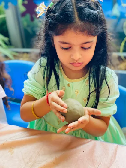 The simple joy of working with clay. This tactile activity is amazing for developing fine motor skills and sensory awareness. In our clay workshops, I guide little hands as they roll, shape, and sculpt, turning a simple ball of clay into their very own creation.