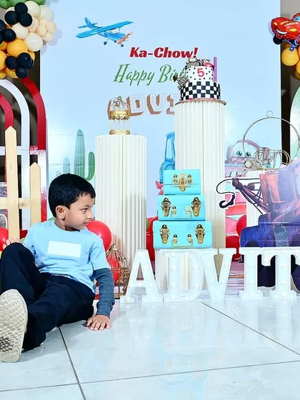 The birthday boy, Advith, relaxing in front of his personalized party setup.