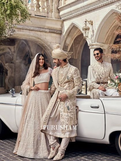 Every love story deserves a royal telling. Here, the bride, groom, and groomsman create a tableau of elegance, with coordinated ivory outfits that speak of shared celebration.