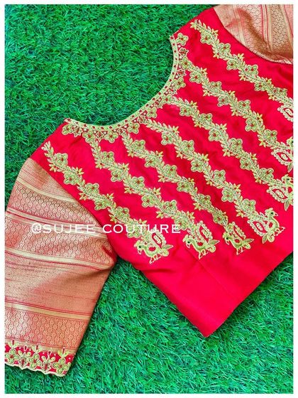 Another view of the red blouse with vertical embroidery. The simple round neck and patterned body make it a statement piece that is both traditional and contemporary.