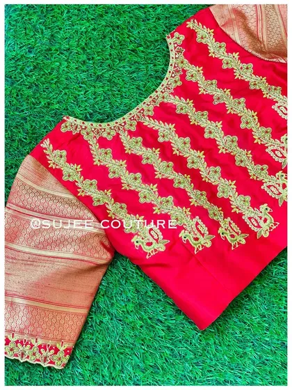 Another view of the red blouse with vertical embroidery. The simple round neck and patterned body make it a statement piece that is both traditional and contemporary.
