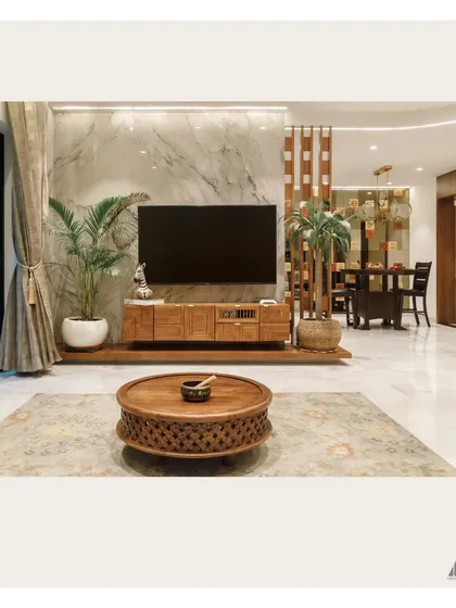 We created a showstopper living room with this contemporary TV unit. The design combines the richness of a carved wood console with the timeless luxury of a full-height marble backing, perfectly capturing the Indo-Contemporary aesthetic our client desired.