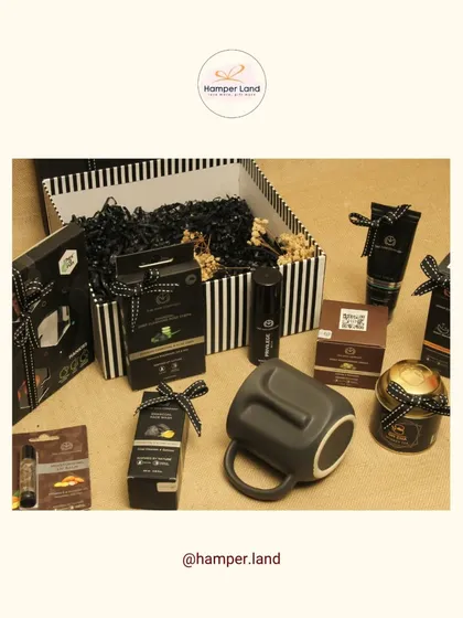 For the dad with classic taste. This sophisticated black and white themed hamper includes a sleek grey mug, men's grooming products, and gourmet snacks, all presented in a stylish striped box.