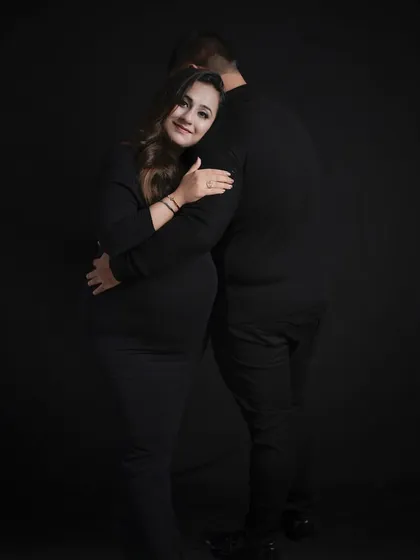 A classic back-hug pose, rendered in beautiful black and white for a timeless and romantic feel.