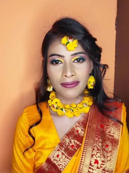 A full-face view of the Haldi look, showing the floral maang tikka and necklace.