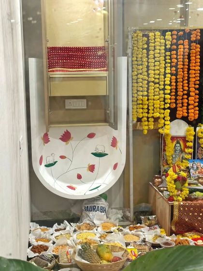 The Pichwai mural in its final setting within the office mandir, surrounded by festive decorations, showing how art integrates with the function of the space.