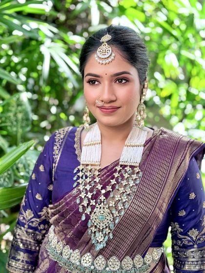 A regal look featuring a vintage weave saree, complemented by antique jewellery and a clean, elegant updo.