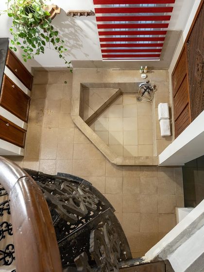 An aerial view of a spiral staircase and a uniquely designed bathroom space within one of our suites.